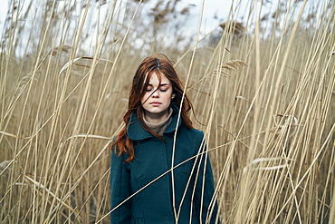 Caucasian woman standing in field with eyes closed