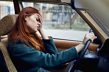 Frustrated Caucasian woman driving car