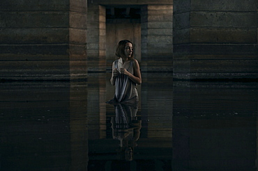 Caucasian woman standing waist deep in water