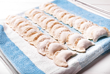 Rows of pierogies on towel