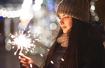 Caucasian woman holding sparkler