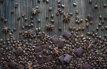 Cocoa beans and chocolate bars on wooden table