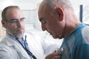 Hispanic doctor examining patient with stethoscope