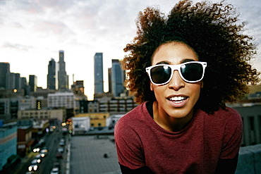 Portrait of smiling Hispanic woman on urban rooftop