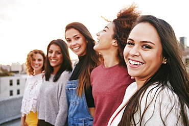 Portrait of smiling women on urban rooftop