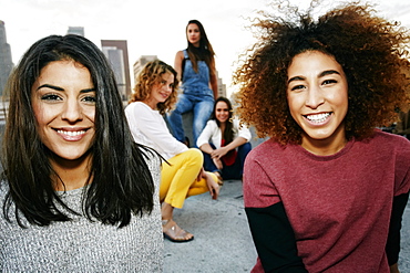 Portrait of smiling women on urban rooftop