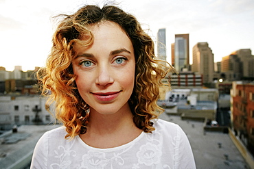 Portrait of smiling Caucasian woman on urban rooftop