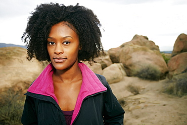 Portrait of serious Black woman posing on rock formation