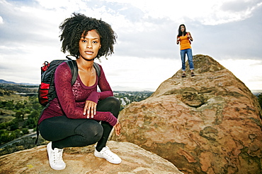 Portrait of serious women posing on rock formation