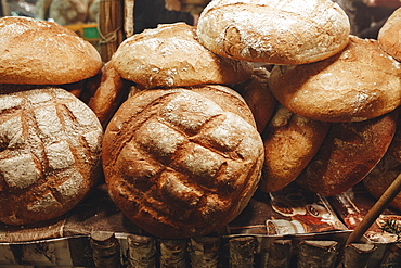 Pile of loaves of bread on table