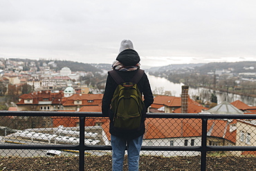 Caucasian woman wearing backpack admiring scenic view of city