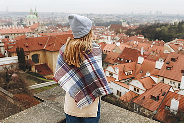 Caucasian woman admiring cityscape from rooftop