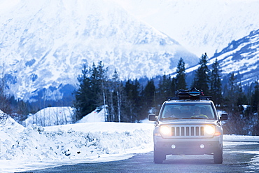 Headlights shining from car driving in winter