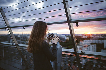 Curious Caucasian admiring scenic view with binoculars