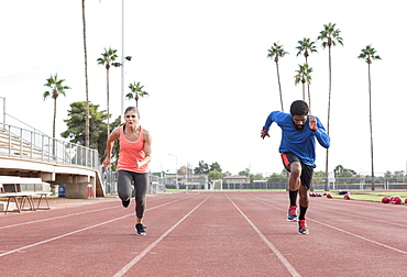 Man and woman running on track