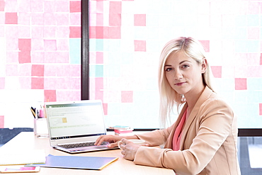 Creative Caucasian businesswoman using laptop