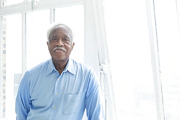 Smiling older Black man near the window