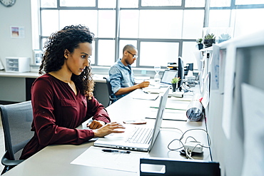 Businesswoman using laptop in office