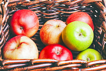 Basket of apples on wooden table