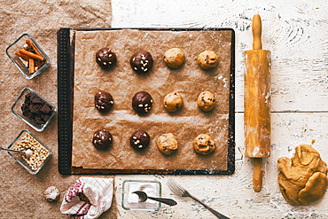 Cookie dough on baking sheet near rolling pin and ingredients