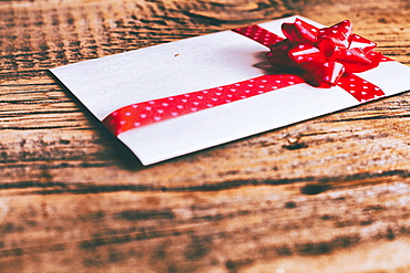 Ribbon on valentine card on wooden table