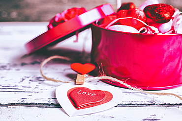 Open box of valentine hearts and decoration on string