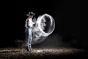 Caucasian cowboy spinning lasso