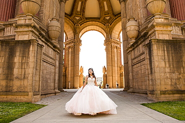 Smiling Hispanic girl wearing gown