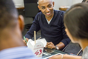 Business people eating food during meeting