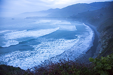 Scenic view of ocean beach and cliffs