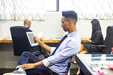 Black man using digital tablet in office