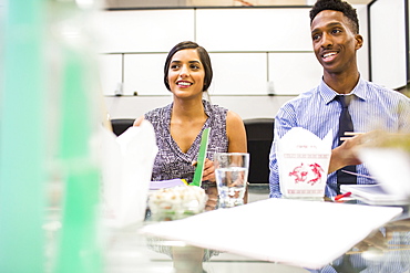 People eating with chopsticks in meeting