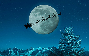 Silhouette of Santa and reindeer flying sleigh near full moon