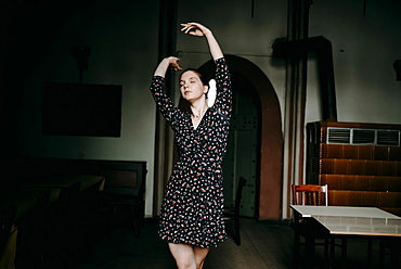 Caucasian woman dancing in livingroom