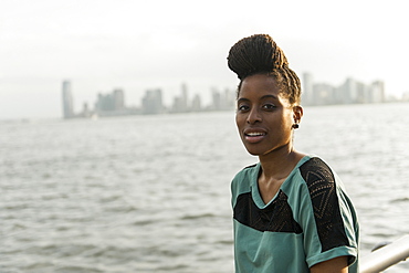 Portrait of African American woman with braids at waterfront