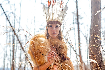 Caucasian woman wearing headdress in forest