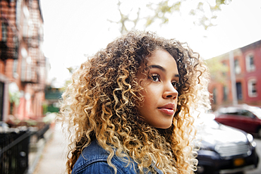 Pensive Mixed Race woman in city