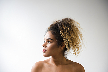 Mixed Race woman with bare shoulders looking away