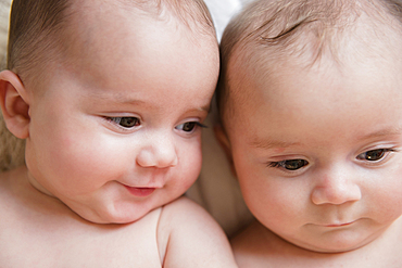 Faces of Caucasian twin baby girls