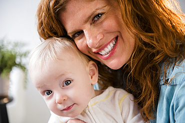 Smiling Caucasian mother holding baby son