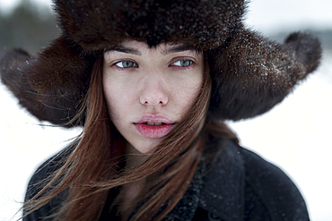 Serious Caucasian woman wearing fur hat and coat in winter