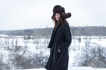 Serious Caucasian woman wearing fur hat and coat in winter