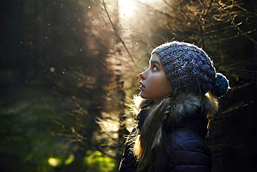 Profile of Caucasian teenage girl in forest