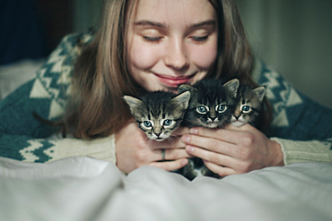 Caucasian woman cuddling kittens