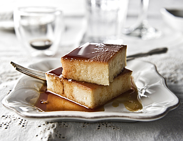 Flan on plate with syrup and fork