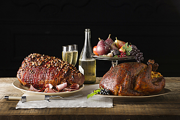 Champagne, fruit and meat on wooden table