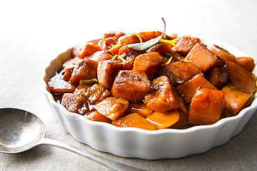 Plate of candied yams and spoon