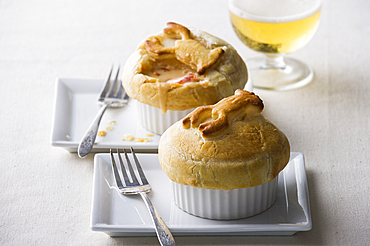 Pot pies with forks on plates