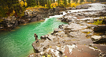 Caucasian man fishing at river