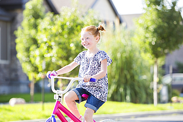 Caucasian girl riding bicycle